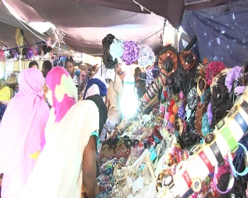 أحد ممرات السوق حيث تنتشر معروضات الثوب التقليدي الملفحة 